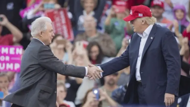 Jeff Sessions (left) and US President-elect Donald Trump during a "thank-you" rally in Alabama in December