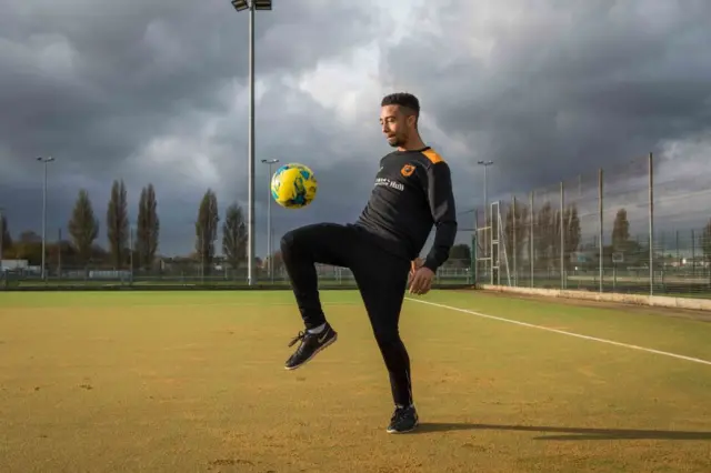 Footballer playing football on the new AstroTurf pitch