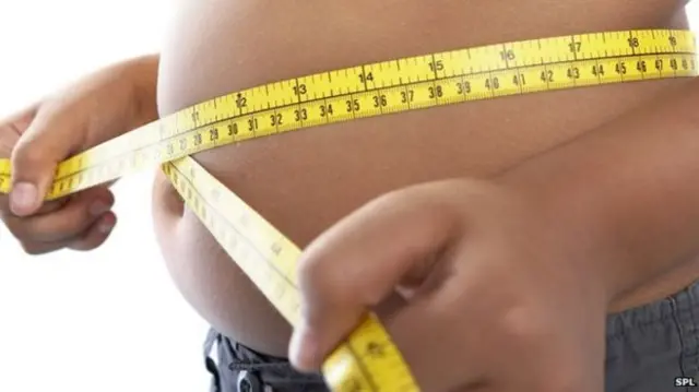 A large stomach being measured