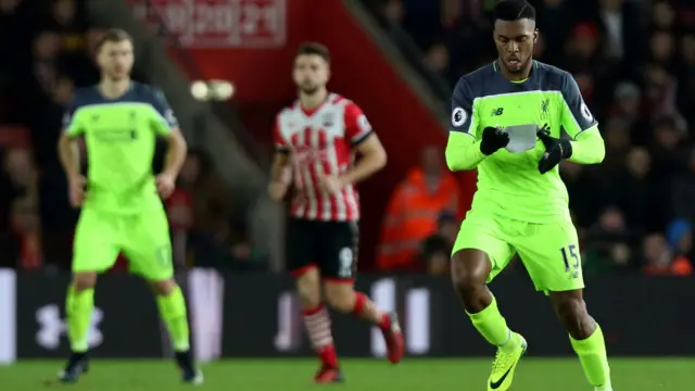 Daniel Sturridge of Liverpool reads a piece of paper