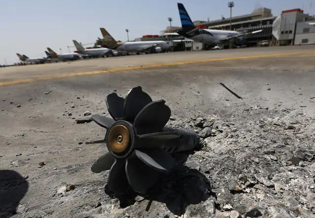 The remains of an explosive device lies on the tarmac of Tripoli international airport in the Libyan capital on July 21, 2014 after Islamist-led militiamen stepped up their assault on the country's main airport, which is controlled by rival fighters.