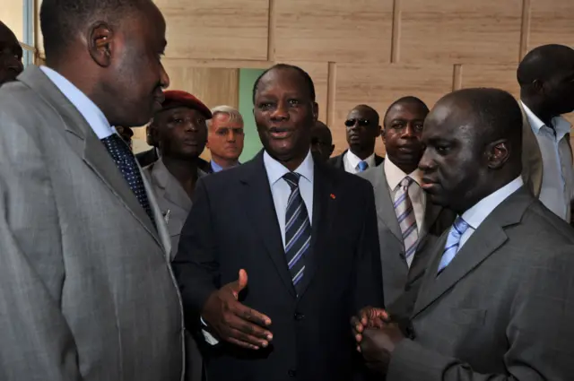 President Ouattara (C) speaks with his new PM Amadou Gon Coulibaly