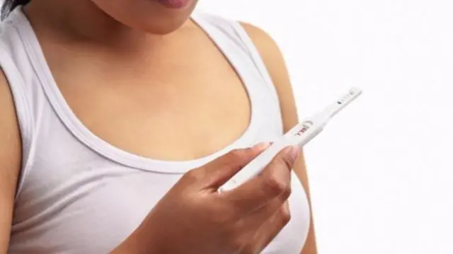 Woman looking at pregnancy test