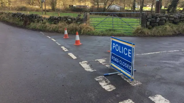 Police sign saying a road has closed in the Moorlands after a fallen tree today