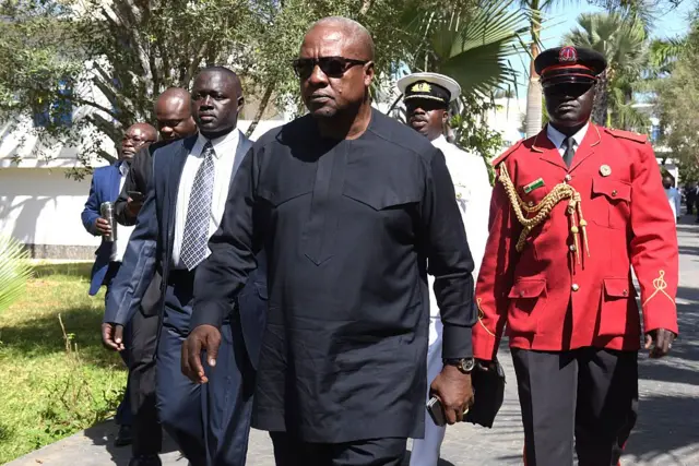 President of Ghana John Dramani Mahama (C) arrives at a hotel in Banjul on December 13, 2016, for a meeting with regional West African leaders