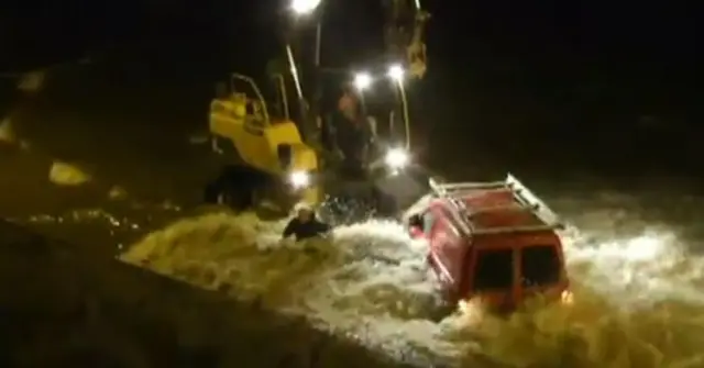 Tidal surge in 2013 showing a car being swept out to sea