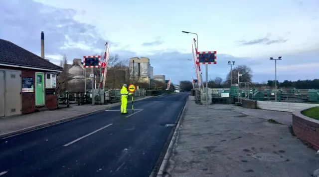 Man with stop sign on road in South Ferriby