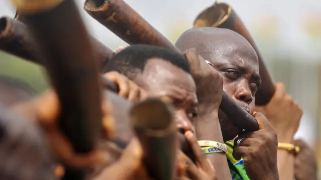 Men blowing horns during the official inauguration ceremony for Ghana's new president Nana Akufo-Addo