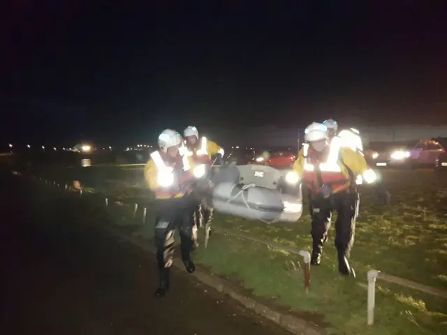 Rescue teams carry lifeboat