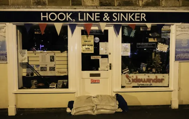 Shop front in Whitby barricaded with sand bags