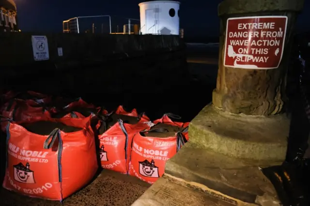 A slipway next to Whitby West pier is barricaded with bags of sand.