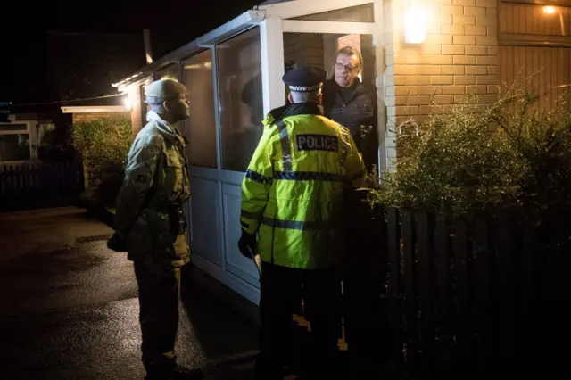 Army officer, police officer and local resident