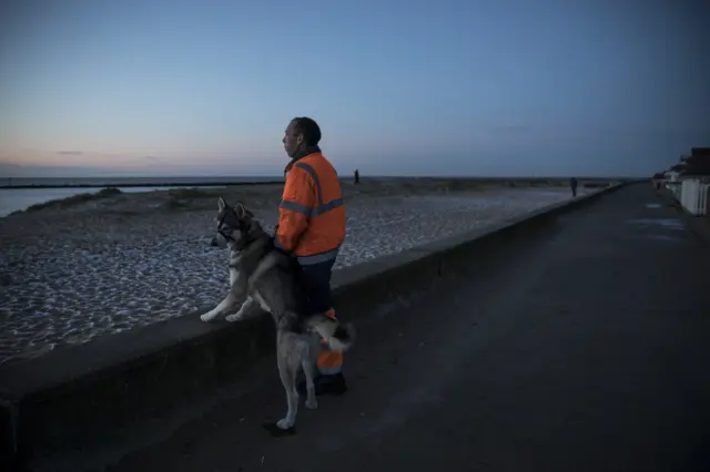 Man and his dog at sea wall