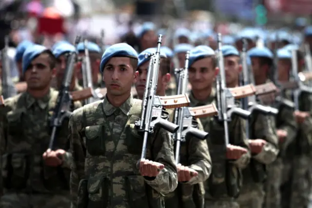 Turkish soldiers attend an army parade marking the 40th anniversary of the Turkish military invasion of Cyprus, on July 20, 2014 in Nicosia, in the northern Turkish-controlled area of the of the east Mediterranean island.