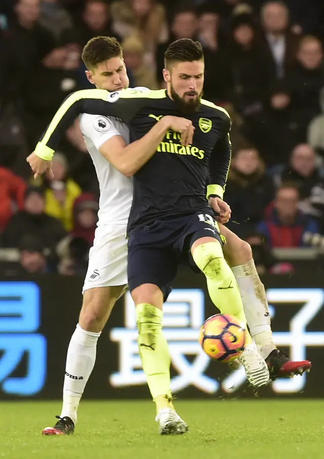 Arsenal"s Olivier Giroud in action with Swansea City"s Federico Fernandez