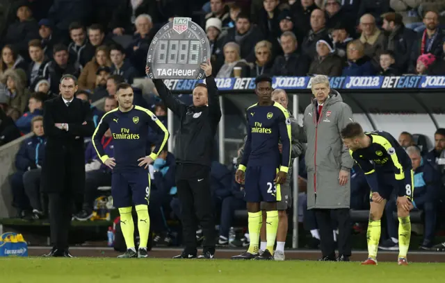 Arsenal"s Danny Welbeck and Lucas Perez prepare to come on as substitutes