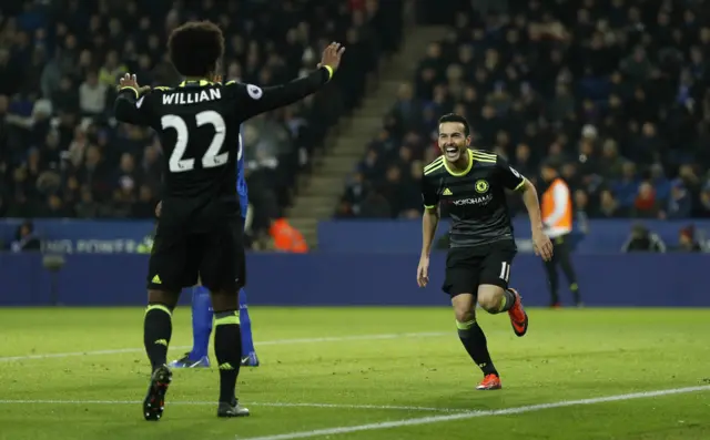 Chelsea"s Pedro celebrates scoring their third goal with Willian