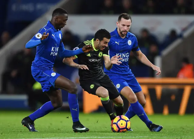 Pedro of Chelsea is tackled by Wilfred Ndidi of Leicester City and Danny Drinkwater of Leicester City