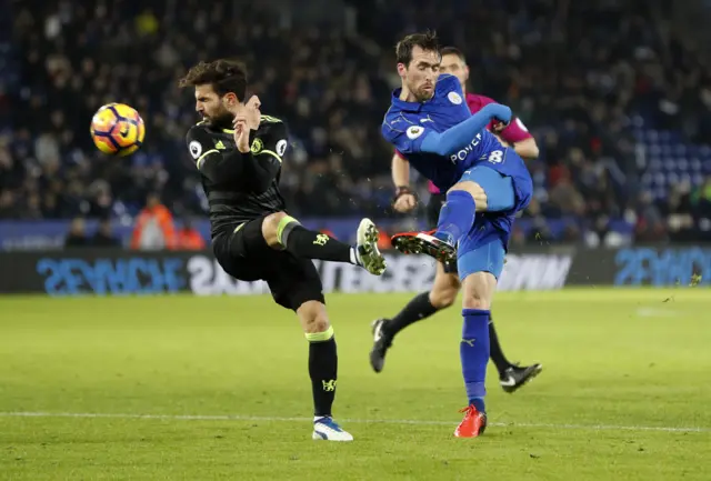 Leicester City"s Christian Fuchs in action with Chelsea"s Cesc Fabregas