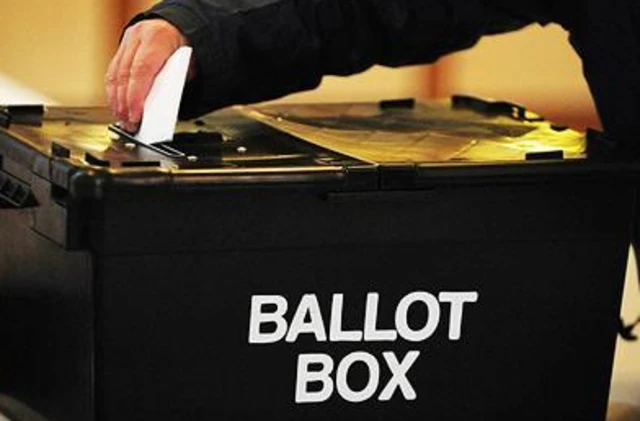 Voter using ballot box