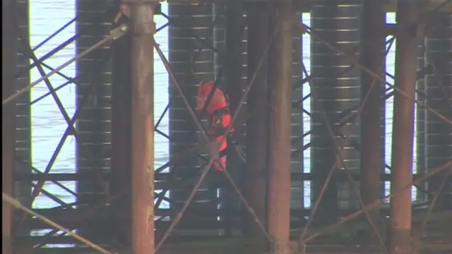 Contractor in reflective clothing working underneath the Pier