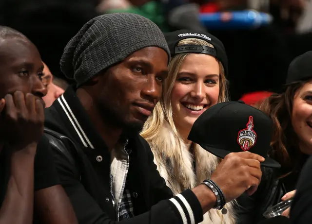 Didier Drogba and Canaidan tennis star Eugenie Bouchard during the a football game between the Toronto Raptors and Washington Wizards