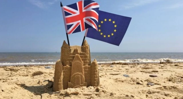 Union and EU flags in sandcastle