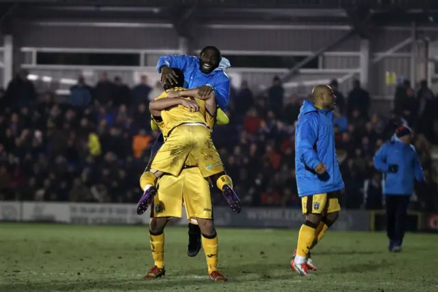 Sutton celebrate their victory against Wimbledon