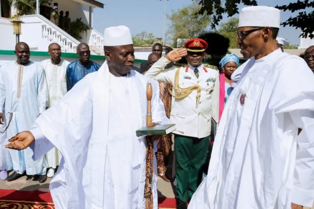 A photograph made available on 14 JAnuary 2017 shows President of Gambia Yahya Jammeh (L) welcoming President of Nigeria Muhammadu Buhari (R) at the State House in Banjul, Gambia, 13 January 2017