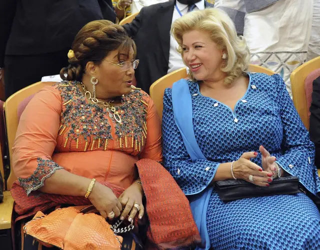 Burkina Faso's ex-First Lady Chantal Compaore (L) and her Ivory Coast counterpart Mrs Ouattara