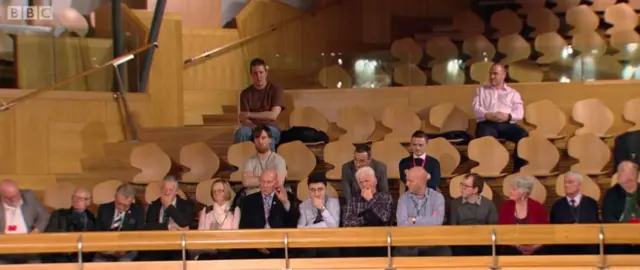 Members who occupied the Caterpillar Plant are present in the public gallery