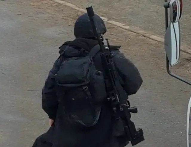 Officer at scene with gun