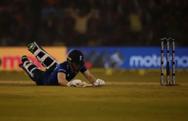 Eoin Morgan dives successfully to make his crease