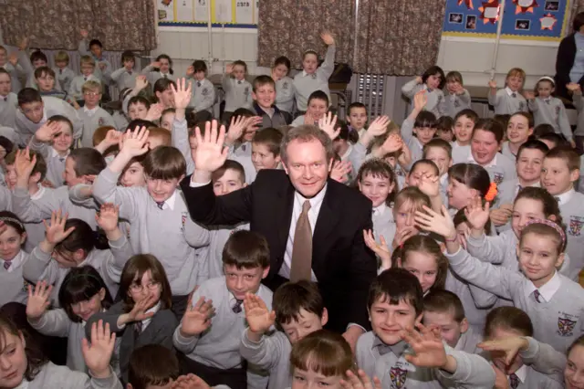 Education Minister Martin McGuinness with from the upper classes of his old school St. Eugines in Derry.