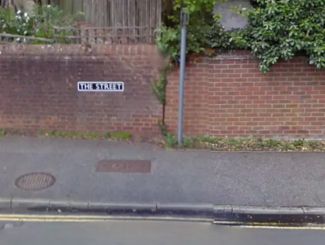 Sign for The Street, on a brick wall