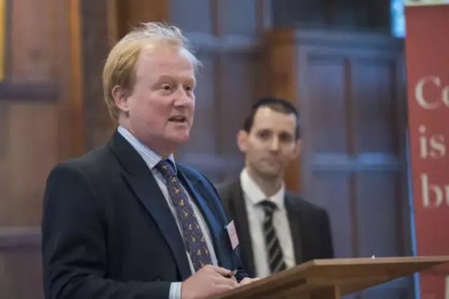 Edward Iliffe, in blue suit and patterned tie