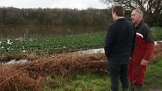 Farmer talking to charity offrical