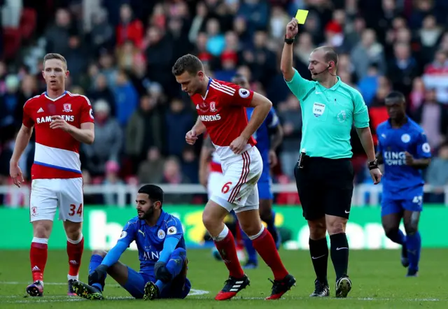 Ben Gibson of Middlesbrough is shown a yellow card