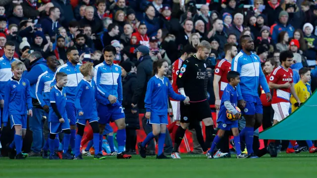 The two teams come on to the pitch ahead of kick-off