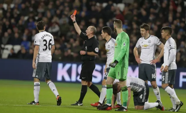 Referee shows a red card