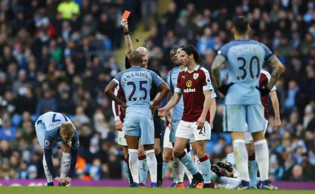 Fernandinho is shown a red