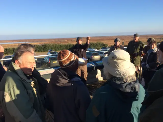 Volunteers grouping at Cley, with the reedbeds and grassland beyond