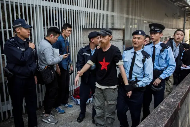 An anti-Trump demonstrator is arrested by police in Hong Kong