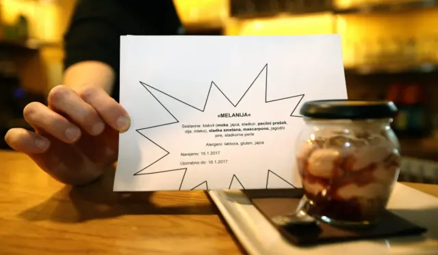 A sign advertises a sweet desert named "Melanija" at a local cafe in downtown Sevnica, Slovenia