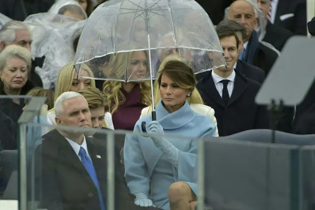 Melania held an umbrella when it started to rain briefly