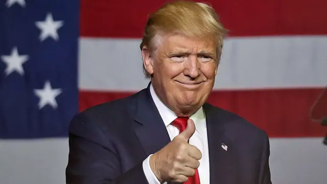 Donald Trump gives a thumbs up during a campaign rally in West Palm Beach, Florida - 13 October 2016