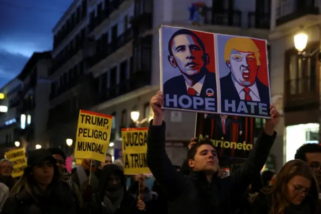 Protesters carry placards in Madrid, Spain