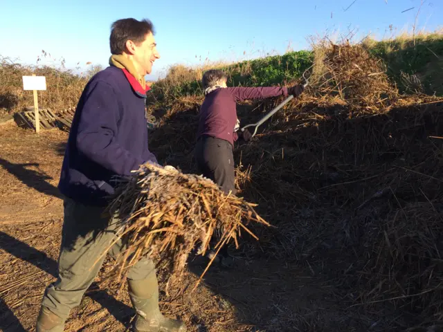 Volunteers clearing thatch