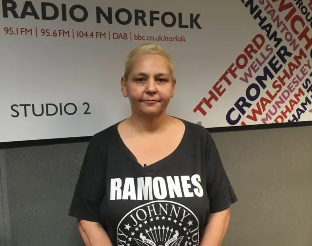 Michelle Tolley, wearing black tee shirt, in BBC Radio Norfolk studio