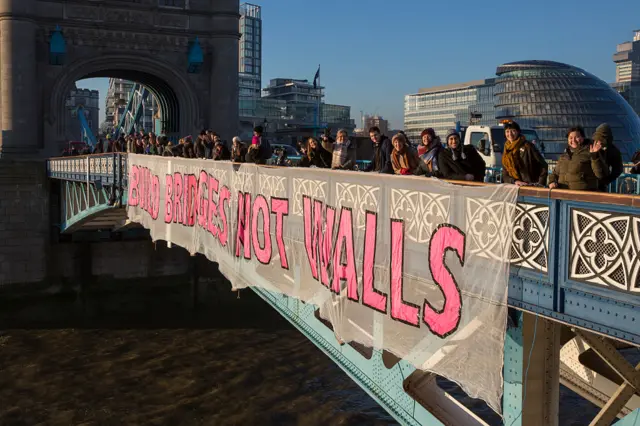 "Build Bridges, Not Walls" hung from Tower Bridge